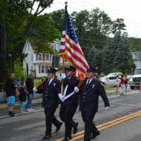 <p>Carmel firefighters march in the Brewster parade.</p>