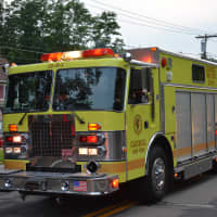 <p>A yellow Carmel firetruck in the Brewster parade.</p>