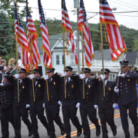 <p>Ossining firefighters march in the Brewster parade.</p>