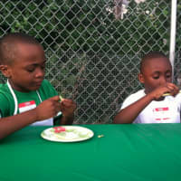 <p>Brothers Jayne, 6, and Derwin Preux, 7, check out yellow beans at Fairgate Farm&#x27;s Farm to Table workshop.</p>