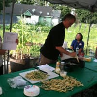 <p>Alexandra Garces, a nutrionist, displays a recipe to a group of about a dozen people at the Farm to Table workshop at Fairgate Farm.</p>