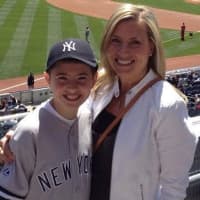 <p>Catherine Calandra stands with her son, Mike Macaione, during a game at Yankee Stadium. </p>