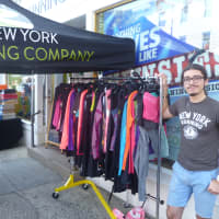 <p>Phil Pognato, of Rye, helps customers shopping sales at New York Running Company. </p>