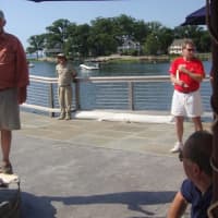 <p>Event organizer Frank Kemp addresses volunteer captains and crew members before casting off Friday.</p>