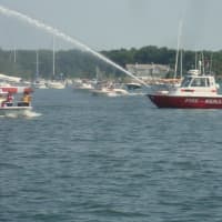 <p>The Noroton Fire Department&#x27;s boat fires its water cannon at the young boaters as they left the harbor.</p>