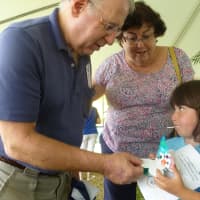 <p>Abigail Oland, 6, shows her grandparents, of Putnam Valley, the paper flower she made. </p>