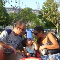 <p>Justin (left) and Jamie Cammarata (right) bring their child, Harley, to the Italian Heritage Festival at Kensico Dam. </p>