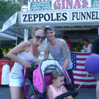 <p>Melinda Montopoli waits on line for zeppoles with her 15-month-old daughter Valentina. </p>
