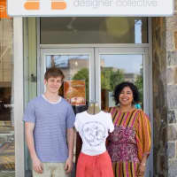 <p>Horace Greeley High School student and T-shirt designer Scott Silver and Dawn-Marie Manwaring, owner, Beehive Designer Collective, outside the co-op boutique in Mount Kisco.</p>