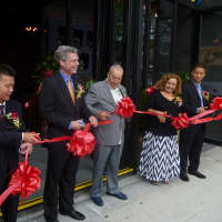 <p>Peter Chen, left, and White Plains Mayor Thomas Roach help cut the ribbon at Red Plum. </p>