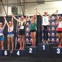 <p>Dana Saidman of Wilton Running Club, on the 7th place pedestal, earned All-American honors at the Junior Olympics in the 1,500 meters.</p>