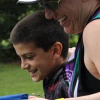<p>Lael Porcelli and her son, Cole, cross the finish line together at the Sleepy Hollow Sprint triathlon in 2011.</p>