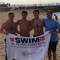 <p>Young swimmers dry off after swimming to raise funding for cancer research and awareness at the Swim Across America-Long Island Sound Swim on July 26.</p>