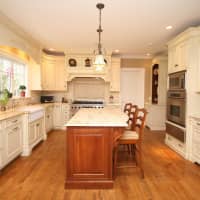 <p>The kitchen at 120 Orchard Lane in New Canaan is spacious and includes top appliances.</p>