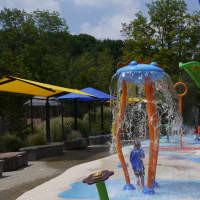 <p>Kids from summer camps at Ridgefield Parks and Recreation test the new Spray Bay facility on Thursday.</p>