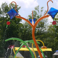 <p>Kids from summer camps at Ridgefield Parks and Recreation test the new Spray Bay facility on Thursday.</p>