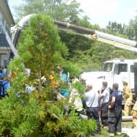 <p>Emergency workers use a City of Rye Vac-truck to clear a collapsed trench that trapped two men. </p>