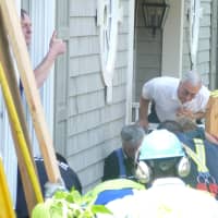 <p>Emergency workers use a City of Rye Vac-truck to clear a collapsed trench that trapped two men. </p>