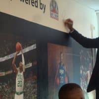 <p>Ray Allen signs the wall of the new computer lab.</p>