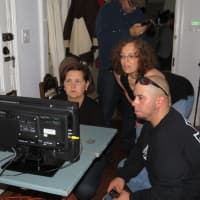 <p>Members of the Paranormal 718 team poring over monitors at the Thomas Paine Cottage in New Rochelle.</p>