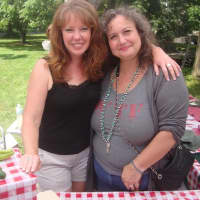 <p>Elizabeth Beller and Annelise McCay of Wakeman Town Farm greet visitors to the chili cook-off.</p>