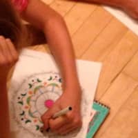 <p>A teen draws a yoga symbol to channel inner creativity and peace. </p>