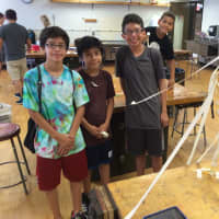 <p>From left, Ethan Delarosa, 13, Jeffrey Lopez, 11, and Christian Del Cid, 13, won the marshallow challenge with a 28-inch tall spaghetti structure. </p>
