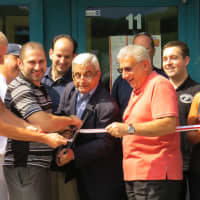 <p>It took a group effort of several New Rochelle figureheads to cut the ribbon in front of the bar. </p>