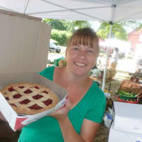 <p>Michelle Tartaglio of Stratford holds up a pie from Oronoque Farms Bakery &amp; Boutique of Shelton at Wilton Farmers Market.</p>