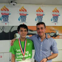 <p>Liam Smith, the Nutmeg Games 2014 Junior U20 Fencing silver medal winner, with his coach Jeremy Goun </p>