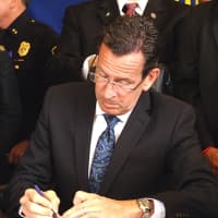 <p>Gov. Dannel Malloy signs the Ignition Interlock bill into law Monday morning at the Fairfield Police Station. </p>