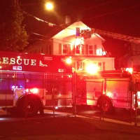 <p>Norwalk firefighters on the scene at a fire on Larsen Street on Monday night.</p>