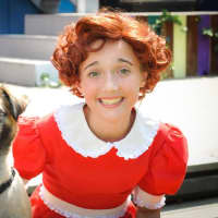 <p>A red wig transforms Olivia Cotter, 12, into Annie. Her sidekick, Coal House, plays Sandy in &#x27;Annie Jr.&#x27;</p>