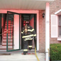 <p>Fairfield Fire Fighter Bassett entered apartment with a hose to extinguish the oven fire.</p>