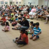 <p>Children flock to see Jonah Cohen, the Science Genie, from the Children&#x27;s Museum in West Hartford on Thursday at the Ferguson Library.</p>