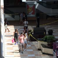 <p>Shoppers stopped and starred at the tapped off area in front of Tourneau, a jewelry stored that was robbed Sunday. </p>