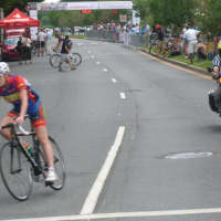 <p>A rider makes a turn during the Danbury Audi Race4Scholars Criterium amateur and professional bicycle races in downtown Danbury on Sunday. It was held on a 1-kilometer course.</p>