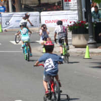 <p>Young racers take the first corner at the Danbury Audi Race4Scholars Criterium amateur and professional races. It was held on a 1-kilometer course in the city.</p>