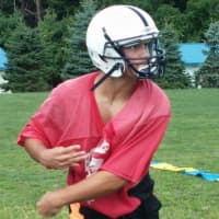 <p>Byram Hills quarterback Louis Filippelli airs our a pass during the opening day of summer practice Monday, Aug. 18. </p>