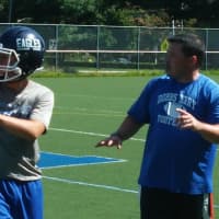<p>Dobbs Ferry head football coach Jim Moran works through a pass-and-defend drill during the second day of summer practice on Tuesday, Aug. 19</p>