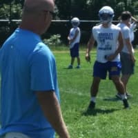 <p>Ardsley High School football coach Colin Maier puts his squad through a drill at summer practice.</p>