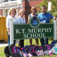 <p>K.T. Murphy Elementary Principal, Frank Rodriguez, right, and Assistant. Principal, Beth Keenan receive backpacks from Kathy Barcello and Maddy Shapiro, who are on the Board of Directors for the Stamford Board of Realtors.
</p>