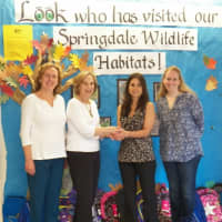 <p>Springdale Elementary Principal, Gloria Manna and Assistant Principal Laura Lynam receive the backpacks  Kathy Barcello and Maddy Shapiro.</p>