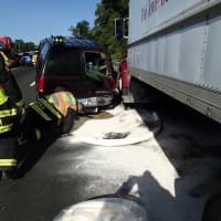<p>Westport firefighters work to contain a spill after a three-vehicle crash on I-95. </p>