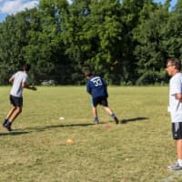 <p>Head coach Alfio Carrabotta watches on as students practice fitness drills.</p>