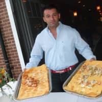 <p>Frank Polozani holding samples of food during Thursday&#x27;s Taste of the Town Stroll in New Canaan.</p>