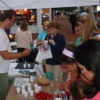 <p>MacKenzie Judson of Mike&#x27;s Organic Delivery hands out a sample during Thursday&#x27;s Taste of the Town Stroll in New Canaan.</p>