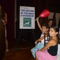 <p>Savanna DiFatta raises her lantern to answer a question during a trivia game at the Light the Night kickoff. </p>