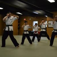 <p>Instructors at The Dojo in Stamford work with some students.</p>