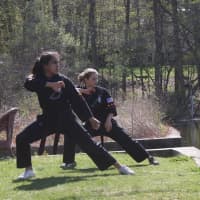 <p>Students at The Dojo focus on their martial arts training. </p>